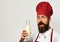 Chef with milkshake or yoghurt. Man with beard holds milk