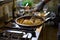 The chef mixes spaghetti quickly in a pan the tomatoes and oysters, hands move and blur.