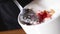 Chef mixing in bowl of ingredients for filling. Frame. Close-up of gloved cook preparing stuffing with caviar for sushi