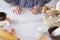 Chef next to the kitchen table, ready to make dough.Woman wearing an apron getting ready for making bakery products, empty space