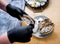 Chef opens a fresh oyster. Dish with open oysters. Restaurant.