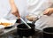 Chef with pans on the stove cooking, Chef preparing food in the kitchen