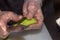 Chef is peeling avocado with sharp japanese knife