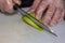 Chef is peeling avocado with sharp japanese knife