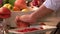 Chef peeling pomegranate at kitchen of restaurant.