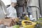 Chef Peeling Tropical Fruit In Kitchen