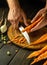 The chef peels carrots on a kitchen cutting board with a knife to prepare vegetable borscht. Vegetarian food concept for