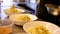 Chef plating fresh pasta noodles into bowls to be served.