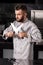 Chef posing at restaurant kitchen. Male chef with crossed knives.