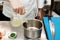 Chef is pouring broth in a bowl