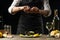 Chef pouring lemon juice with mussels with white wine salad on a dark background