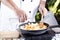 Chef pouring soup to the pan for cooking Japanese pork curry