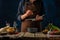 The chef prepares a classic Caesar salad. He crushes the garlic through a sauce press. Lots of ingredients. Beautiful composition