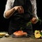 The chef prepares fresh salmon fish, freshly salted trout, sprinkled with rosemary leaves with ingredients. Salmon steak,