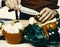 Chef prepares meal. Male hands cut mushroom with knife, apron on background.