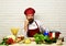 Chef prepares meal. Man with beard holds chin