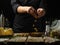 The chef prepares the olives for the Italian focaccia bread. Levitation. The ingredients are on the table side by side. Vegetarian