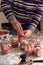 Chef prepares pre-house conservation. A man puts pieces of raw meat in glass jars.