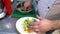 Chef prepares salad. Hands puts lettuce leaves