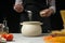 The chef prepares spaghetti and pasta, salt water, against a dark background, the concept of cooking