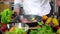 Chef prepares steak for cooking in kitchen