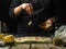 The chef prepares traditional Italian focaccia bread. He tosses garlic on the glass dough prepared for baking. Levitation.