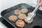 Chef preparing burgers cutlet frying on pan