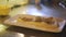 Chef preparing creamy parmesan polenta with chopped turkey meat