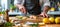 Chef preparing grilled fish filet in creamy butter lemon or cajun sauce with herbs