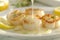 Chef preparing grilled scallops in creamy butter lemon or cajun spicy sauce with herbs