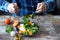 Chef preparing a healthy salad. Male hand mixed salad with mozzarella and tangerine.