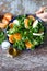 Chef preparing a healthy salad. Male hand mixed salad with mozzarella and tangerine.