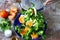 Chef preparing a healthy salad. Male hand mixed salad with mozzarella and tangerine.