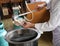 A chef is preparing meat ball noodle