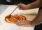 chef preparing pizza with fried tomato spread