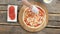 Chef preparing pizza, wooden table.