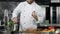 Chef preparing to cook meat at kitchen. Closeup chef hands sharpening knife.