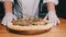 The Chef Presents Freshly Made Pizza on the Table in the Restaurant. Slow Motion