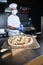 Chef  with protective coronavirus face mask preparing pizza