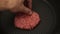 A chef puts beef patties on the grill. A juicy beef cutlet, fried in a pan. Close-up of a beef cutlet for a burger on the grill.