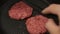 A chef puts beef patties on the grill. A juicy beef cutlet, fried in a pan. Close-up of a beef cutlet for a burger on the grill.