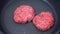 A chef puts beef patties on the grill. A juicy beef cutlet, fried in a pan. Close-up of beef cutlet for a burger on the grill