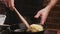 Chef puts spaghetti pasta in a frying pan with fried mushrooms, garlic and parsley in a restaurant kitchen. Food