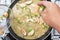 Chef putting Thai Brinjal for cooking green curry