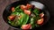 Chef putting tomatoes in salad. Vegetables salad with tomatoes, spinach, arugula