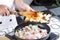 Chef putting vegetable to the pan for cooking Japanes pork curry