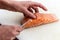 Chef removing fish bone from salmon