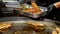 Chef removing whole grilled fish off a griddle