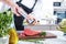 Chef in restaurant kitchen cooking,he is cutting meat or steak