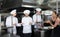 Chef of restaurant with team of cooks preparing food